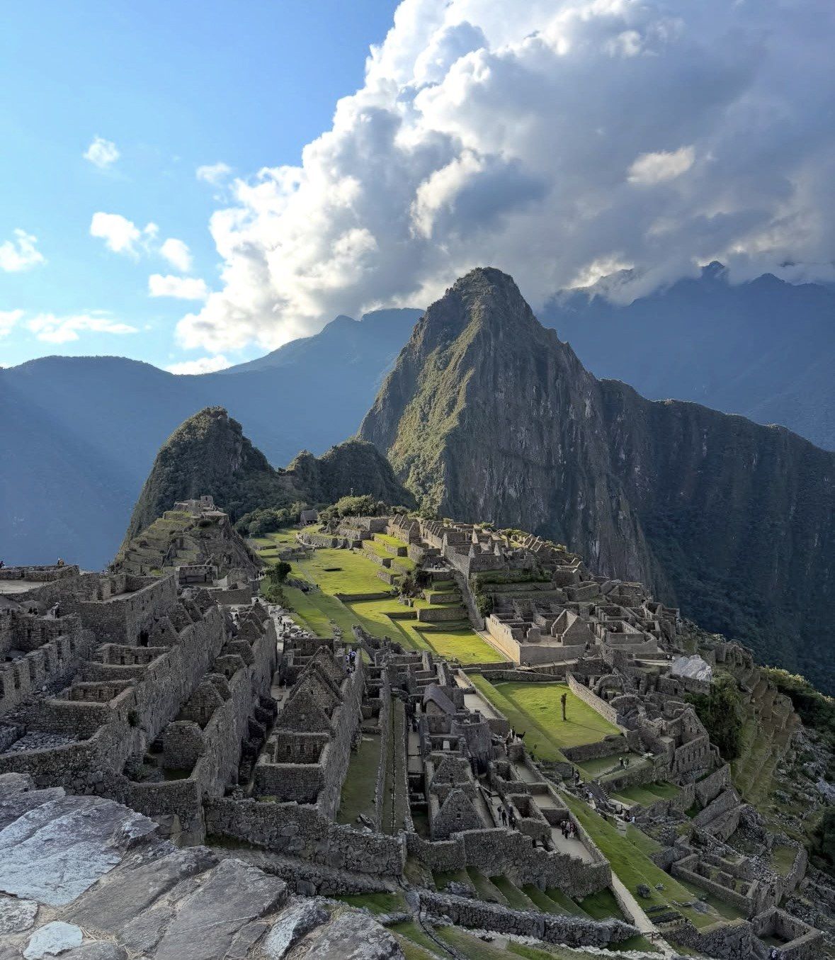Central plaza and stone houses of Machu Picchu in afternoon light