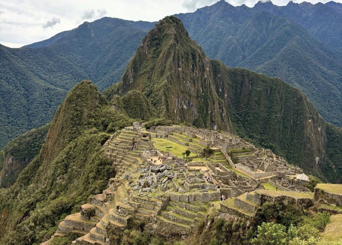 Stone city of Machu Picchu spread below the green Huayna Picchu peak